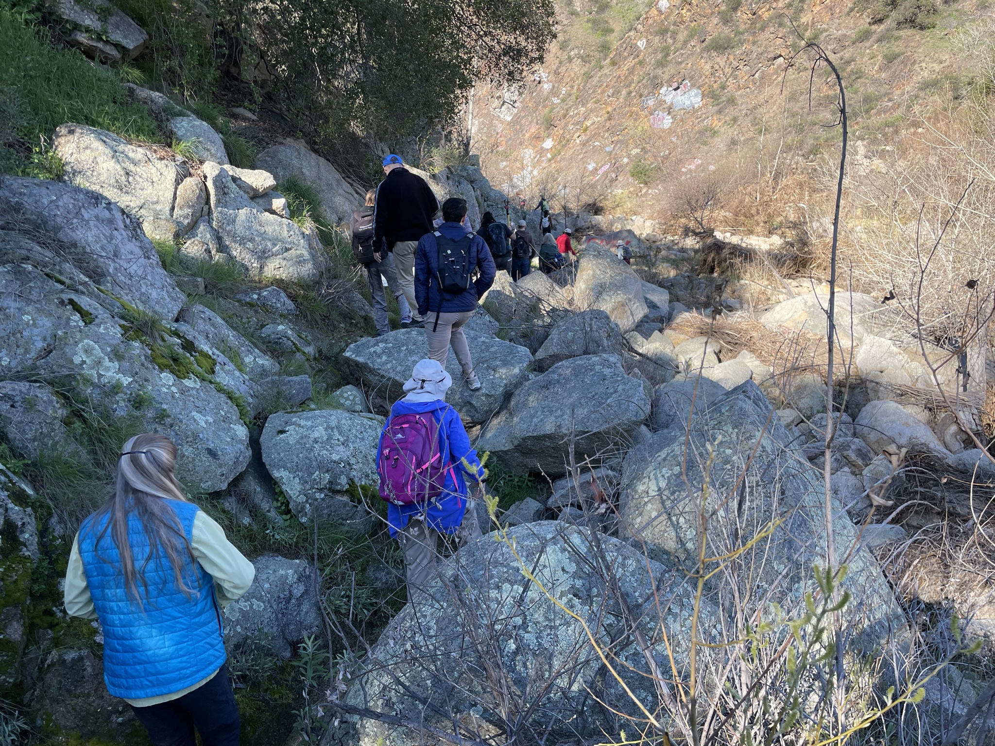group of 10 hiking through rocks 