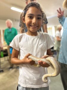 young person holding a snake 